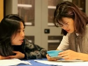 Handling Session at the British Museum: A lady on the right examines a turquoise dish, a lady on the left watches