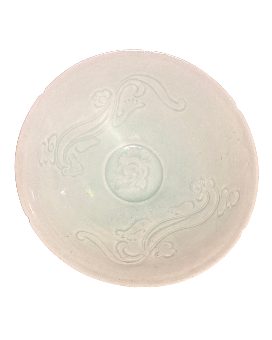 underneath of a pearly white bowl showing two engraved designs